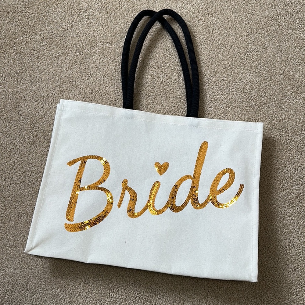 Natural canvas “Bride” tote with gold sequins and black handles. Never been used